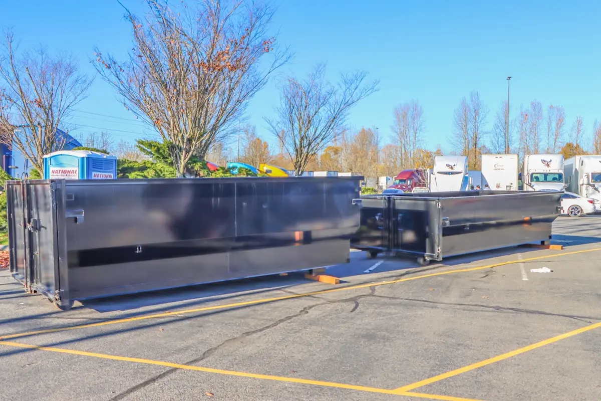 Professional dumpster rental service with roll-off container on residential driveway in Garwood